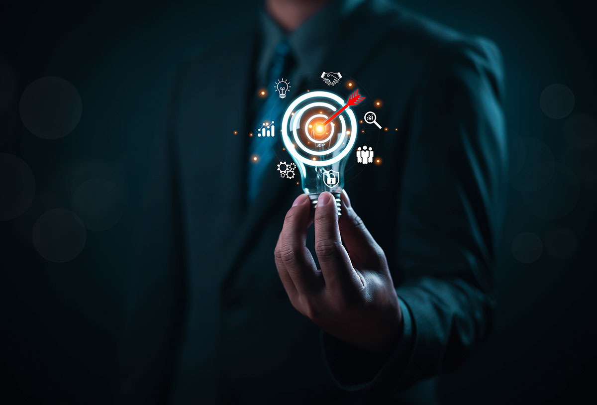 business man holding lightbulb with business strategy icons
